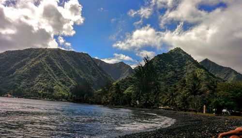 Scenic view of river against cloudy sky