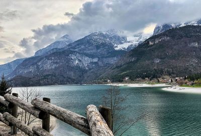 Scenic view of lake by mountains against sky