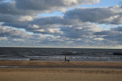 Scenic view of sea against cloudy sky