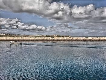 Scenic view of sea against cloudy sky