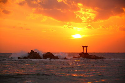 Offshore torii and sunrise