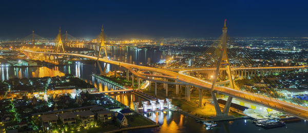 High angle view of illuminated bridge and buildings at night