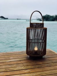 Close-up of wicker basket on table against sea