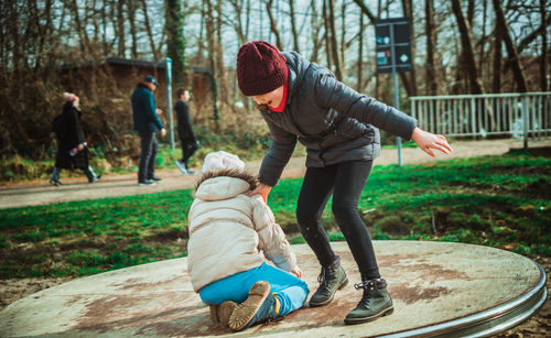 Full length two girls playing in park during winter