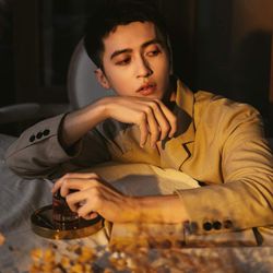 Portrait of young man sitting at home