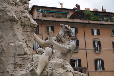 Low angle view of statue against building