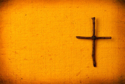 Close-up of cross on wood