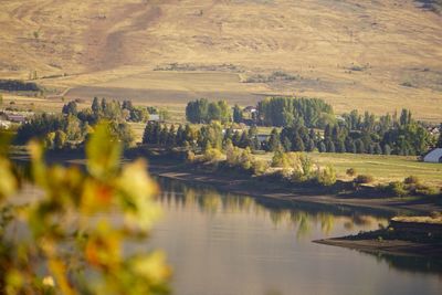 Scenic view of river by mountains