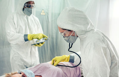 Healthcare workers examining patient in clinic