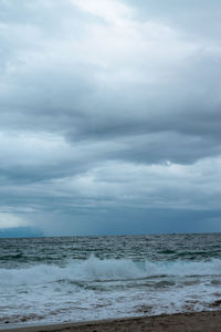 Scenic view of sea against cloudy sky