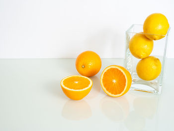 Yellow fruits in glass on table
