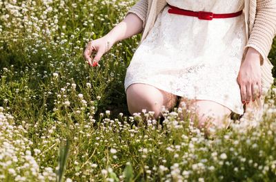 Woman picking wildflowers in meadow