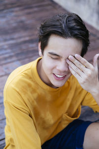 Young smiling boy sitting outdoors