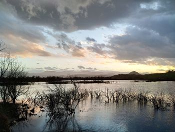 Scenic view of lake against sky during sunset