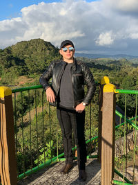 Young man in black jacket style and black clothes on the top of a viewpoint in nicaragua