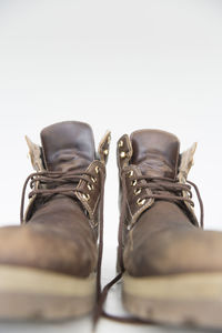 Close-up of boots against white background