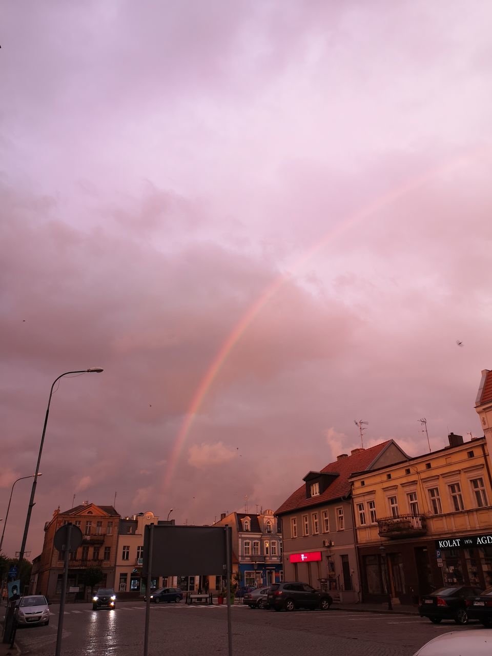 RAINBOW OVER CITY STREET AND BUILDINGS