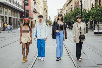 Young man with women walking on street in city