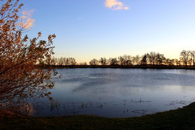 Scenic view of calm lake against sky