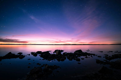 Scenic view of sea against sky at night