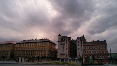 Buildings against cloudy sky