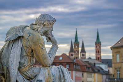 Dramatic statue against sky