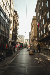 City street and buildings against sky