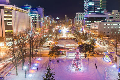 Illuminated cityscape against sky at night
