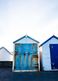 Rows of beach huts at sunset on goodrington sands, devon.