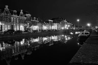 Reflection of illuminated buildings on river at night