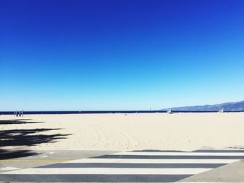 View of trees against clear blue sky