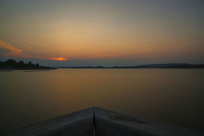 Scenic view of lake against romantic sky at sunset