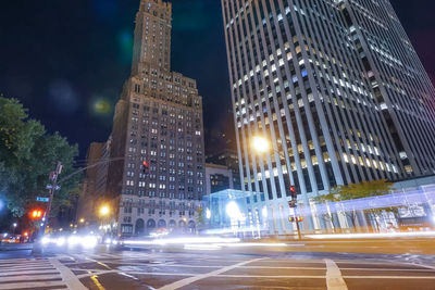 Illuminated city street and buildings at night