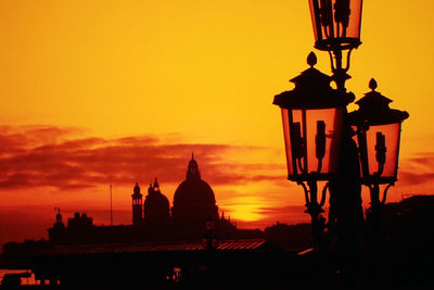 Lamp post by santa maria della salute against sky during sunset