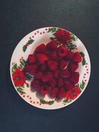 High angle view of chopped fruits in plate on table