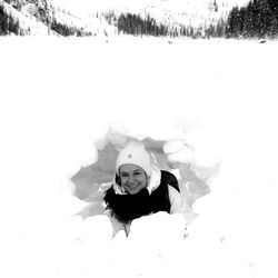 Portrait of smiling young woman in snow