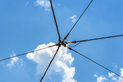 Low angle view of cables against blue sky