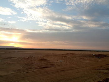 Scenic view of beach against sky during sunset
