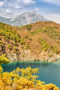 Scenic view of lake and mountains against sky