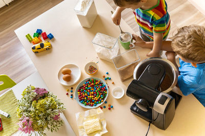 High angle view of people and stuffed toy on table