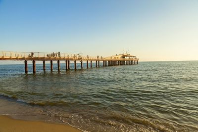 Pier over sea against clear sky