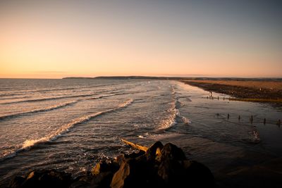 Scenic view of sea against clear sky during sunset