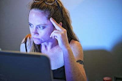 Portrait of young woman using laptop