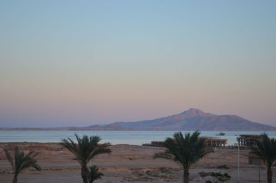 Scenic view of sea against clear sky during sunset