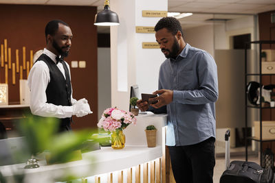 Side view of man using digital tablet in office