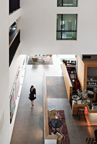 High angle view of businesswoman walking in corridor in office