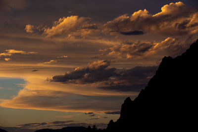 Low angle view of silhouette mountains against sky during sunset