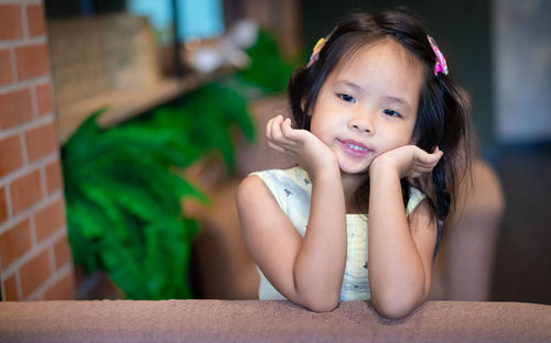 Portrait of cute girl sitting outdoors