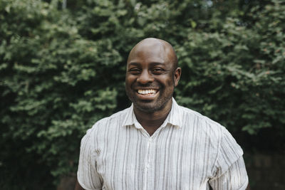 Portrait of smiling man standing outdoors