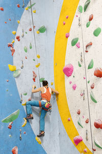 Woman climbing on wall